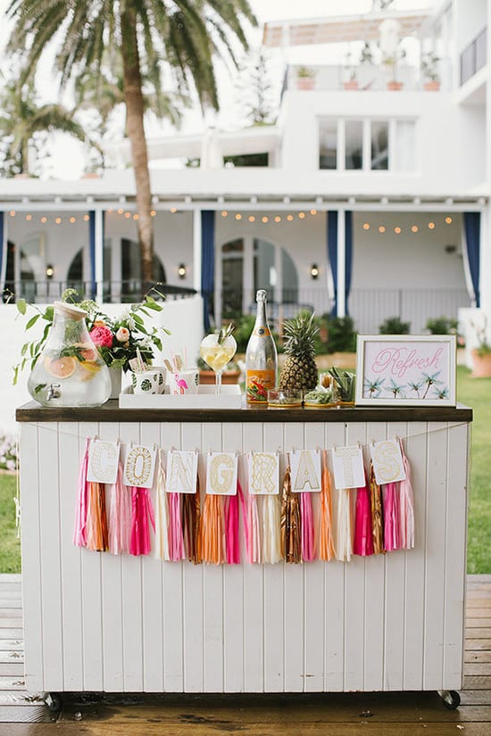 Bright tropical wedding cocktail hour bar | Heart and Colour via 100 Layer Cake