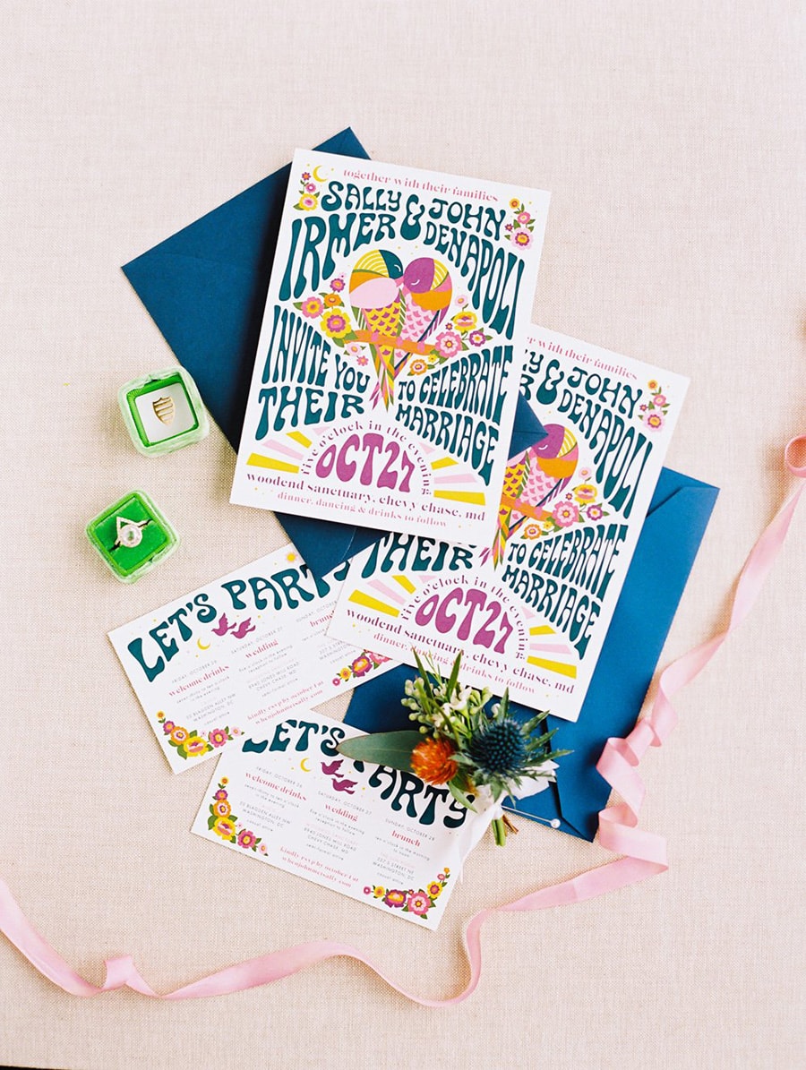 Electric Disco Wedding Ideas |  Retro 70s inspired wedding invitation suite in a purple, pink, blue, orange and yellow palette featuring groovy lettering and an illustration of two birds sitting together in the shape of a heart on a branch surrounded by flowers. | Photography: Bonnie Sen Photography via Washingtonian