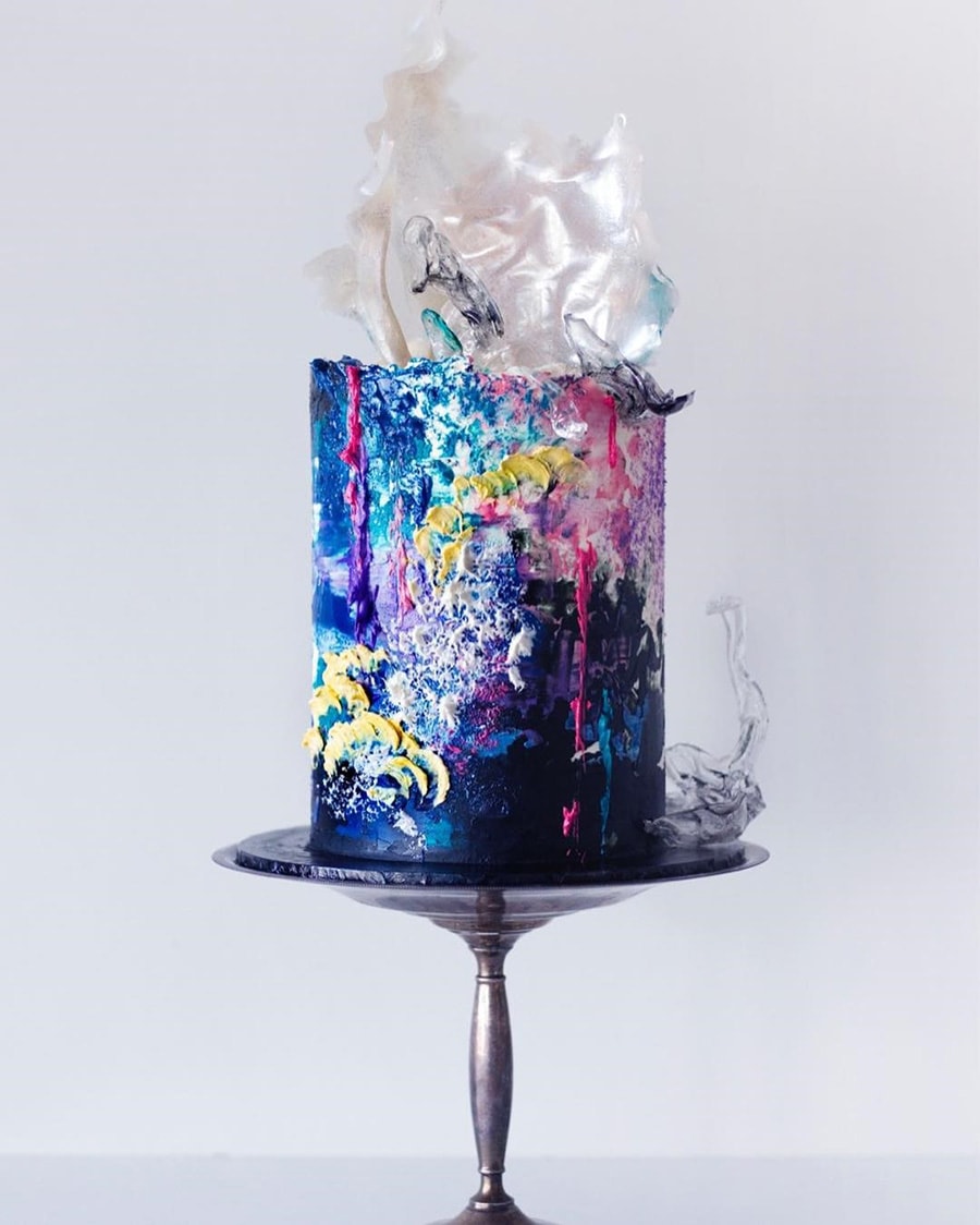 Electric Disco Wedding Ideas |  Painted buttercream wedding cake featuring graffiti style textures including yellow scales, hot pink drips and watercolour dark blue, aqua and purple icing topped with white and black isomalt sails | Photography: Sugar Sugar Cake School