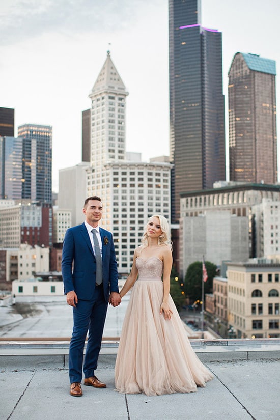 Bride wearing champagne wedding dress and groom in navy suit | Angela Shae via 100 Layer Cake