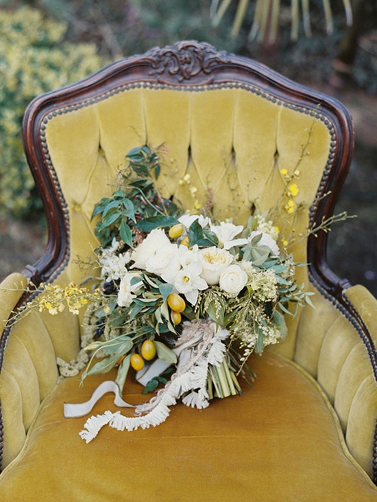 Green, white and yellow wedding bouquet on mustard velvet chair | Lauren Balingit via 100 Layer Cake