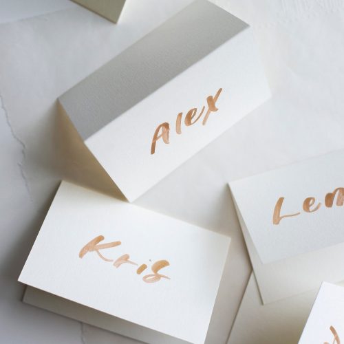Cream Tented Wedding Placecards with Modern Gold Brush Lettering