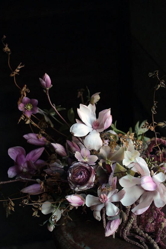 Moody botanical wedding centrepiece featuring purple and white flowers on a black backdrop | Sarah Ryhanen