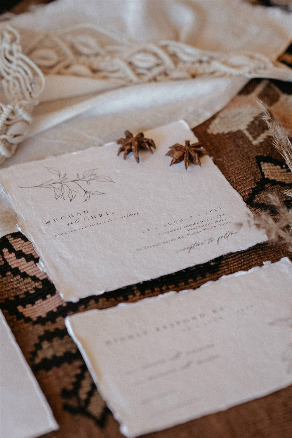 Outdoor Festival Bohemian Wedding Inspiration | A boho wedding stationery suite on white deckle edge cotton paper features a fine line foliage motif and modern vintage serif font paired with flowing script. The suite consists of a wedding invitation, a card providing "The Details" on the reception, gifts and attire, a "Kindly Respond By" RSVP card, an escort card with the guest name and table number, and a dinner menu. | Photography: Shae Estella Photo
