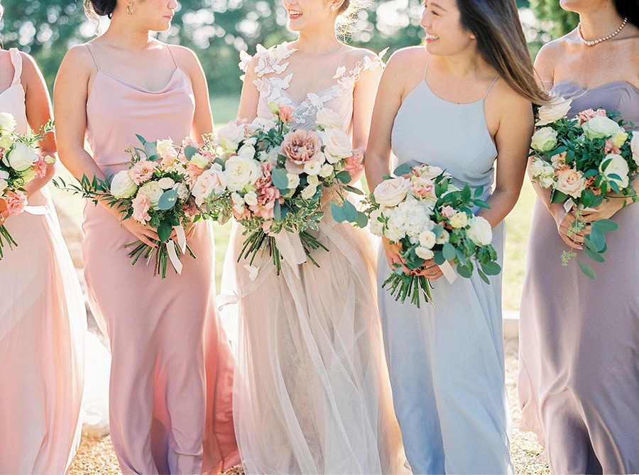 Spring Pastel Wedding Ideas | Romantic pastel bridesmaid dresses in pale blue, blush pink and purple paired with soft pink and white bouquets. | Photography: Branco Prata via Martha Stewart Weddings
