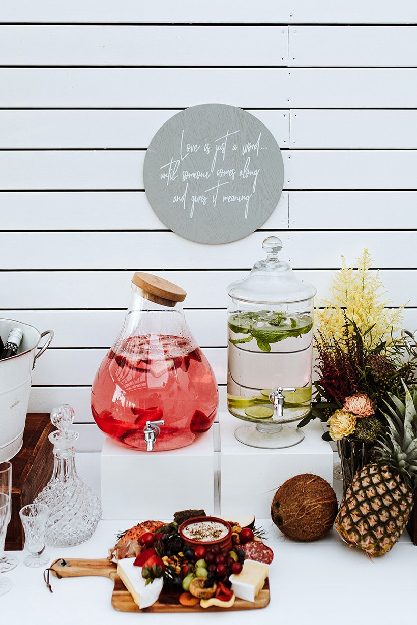 Modern tropical drinks station for wedding cocktail hour with coconuts and pineapples | Alex Jackson Photography